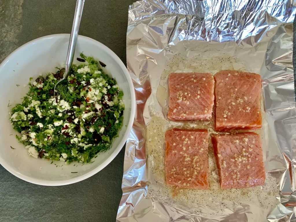 baked salmon on a foil and a white plate