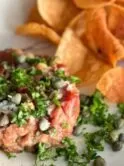 steak tartare on white plate with spoon